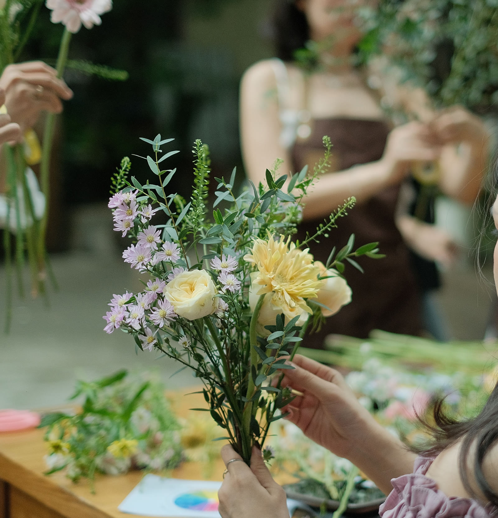 Hands selecting seasonal stems